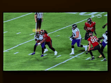 a football game is being played on a tv screen and the player in red is number 98