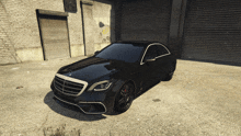 a black mercedes is parked in front of a garage door