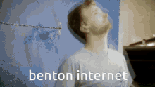 a blurry picture of a man with benton internet written in white