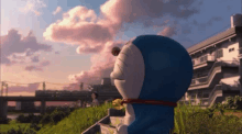 a cartoon character named doraemon is standing in a field