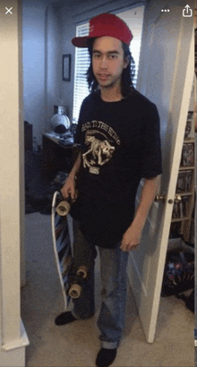 a man wearing a black shirt that says back to the being