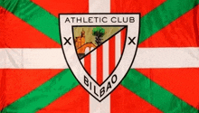 a red white and green flag with athletic club bilbao written on it