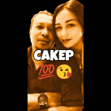 a man and a woman are posing for a picture . the woman is wearing a shirt that says `` cakep '' .