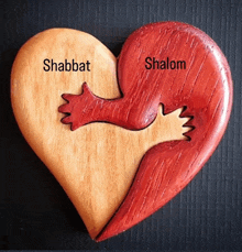 a wooden heart with the words shabbat shalom on it