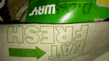 a paper towel that says " eat fresh " next to a subway bag