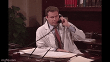 a man in a lab coat talking on a phone