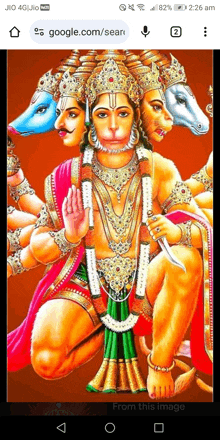 a phone screen shows a painting of a deity with four faces