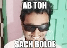 a man wearing sunglasses with the words ab toh sach bolde above him