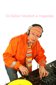 a man wearing headphones and an orange jacket is playing music and the words dj.gabor kezeket a magasba can be seen above