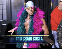 a man wearing a feather boa and sunglasses has # 13 craig costa on a sign