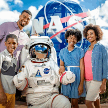 a group of people posing with a nasa astronaut