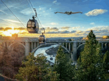 a cable car is going over a bridge over a river at sunset