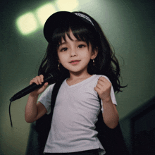 a little girl is holding a microphone and wearing a black hat that says altitude