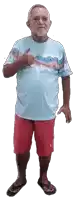 a man wearing a blue shirt and red shorts is giving a thumbs up