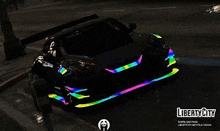 a black car with rainbow lights on it is driving down a street in a video game .