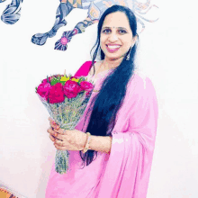 a woman in a pink dress is holding a bouquet of flowers and smiling