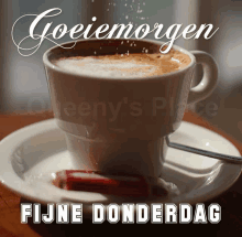 a cup of coffee on a saucer with the words fijne donderdag above it