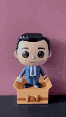 a funko pop figurine of a man in a suit and tie