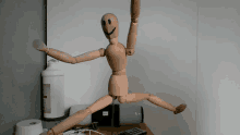 a wooden mannequin with a smiley face on it