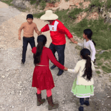 a man in a red jacket with the letter p on it is holding hands with a girl in a red dress