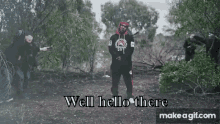 a man in a hoodie is standing in the middle of a forest with the words well hello there on the bottom