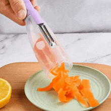 a person is peeling carrots on a plate with a purple handle