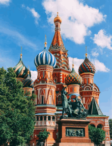 a colorful building with a statue in front of it that says " russia "