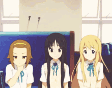 three anime girls are sitting next to each other on a bench