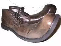 a pair of brown shoes with black laces and a black rubber sole