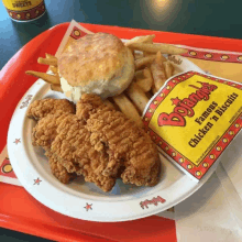 a plate of fried chicken french fries and a biscuit from big tangles