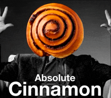 a man in a suit has a cinnamon roll in front of his head with the words absolute cinnamon below it