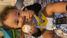 a baby laying on a bed holding a book titled pie