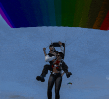 a man carrying a woman in a parachute with a rainbow colored parachute behind them