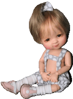 a baby doll wearing overalls and pink shoes