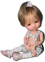 a baby doll wearing overalls and pink shoes