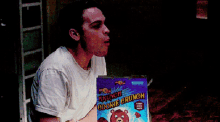 a man eating a box of crunch cookie crunch cereal