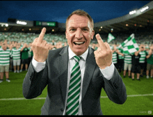 a man wearing a suit and tie giving the middle finger