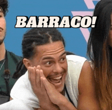 a man with dreadlocks is smiling with the words barraco behind him