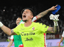 a soccer player wearing a kappa casillo jersey screams in the air