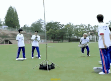 a group of young men are playing a game of frisbee on a field with a yellow sticker that says gonshot