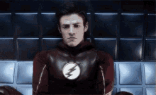 a man in a flash costume is sitting down