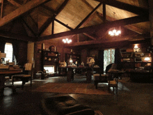 a living room with a fireplace and lots of bookshelves