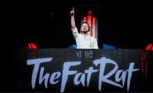 a man stands in front of a sign that says the fat rat on it