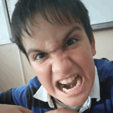 a young boy making a very angry face with his mouth open