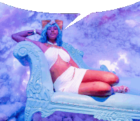 a woman with blue hair sits on a blue couch