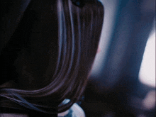 a close up of a woman 's hair with a blurred background