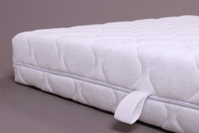 a white mattress with a white strap around the corner