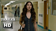 a woman in a black dress is walking down a hallway with the words trailer hd on the bottom right