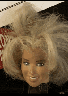 a barbie doll head is smiling in front of a sign that says ' no smoking '