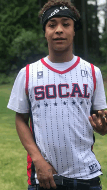 a man wearing a socal jersey and a headband